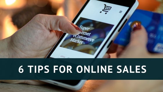 Hand holding a phone open to an online shopping page and holding a credit card, image used for Lisa Laporte blog about tips for online sales