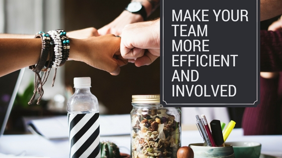 People sitting around a table and fist bumping over paperwork and miscellaneous items, image used for Lisa Laporte blog about how to keep your team involved and motivated